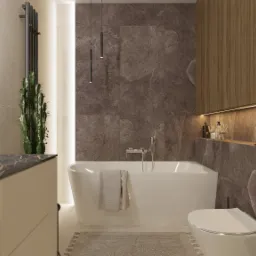 Nowoczesna łazienka z wolnostojącą wanną, marmurowymi płytkami w odcieniach brązu, drewnianymi szafkami podświetlonymi LED oraz wysokim kaktusem obok grzejnika.