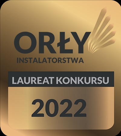 Złota odznaka 'Orły Instalatorstwa' z napisem 'Laureat Konkursu 2022' i stylizowanymi promieniami słonecznymi.