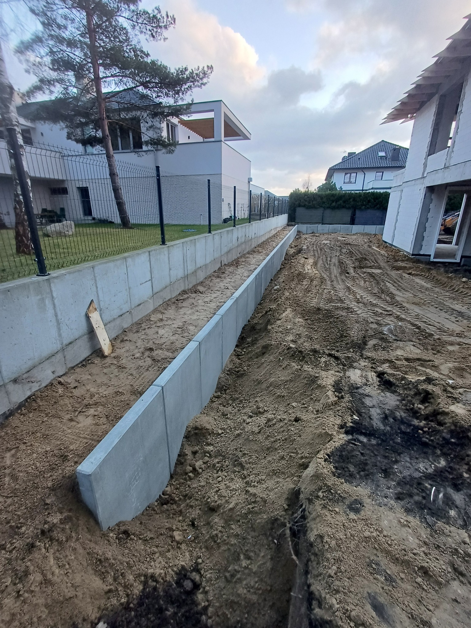 Wykop pod fundamenty w Szczecinie z widocznymi betonowymi ścianami szalunkowymi, przygotowany pod dalsze prace budowlane.