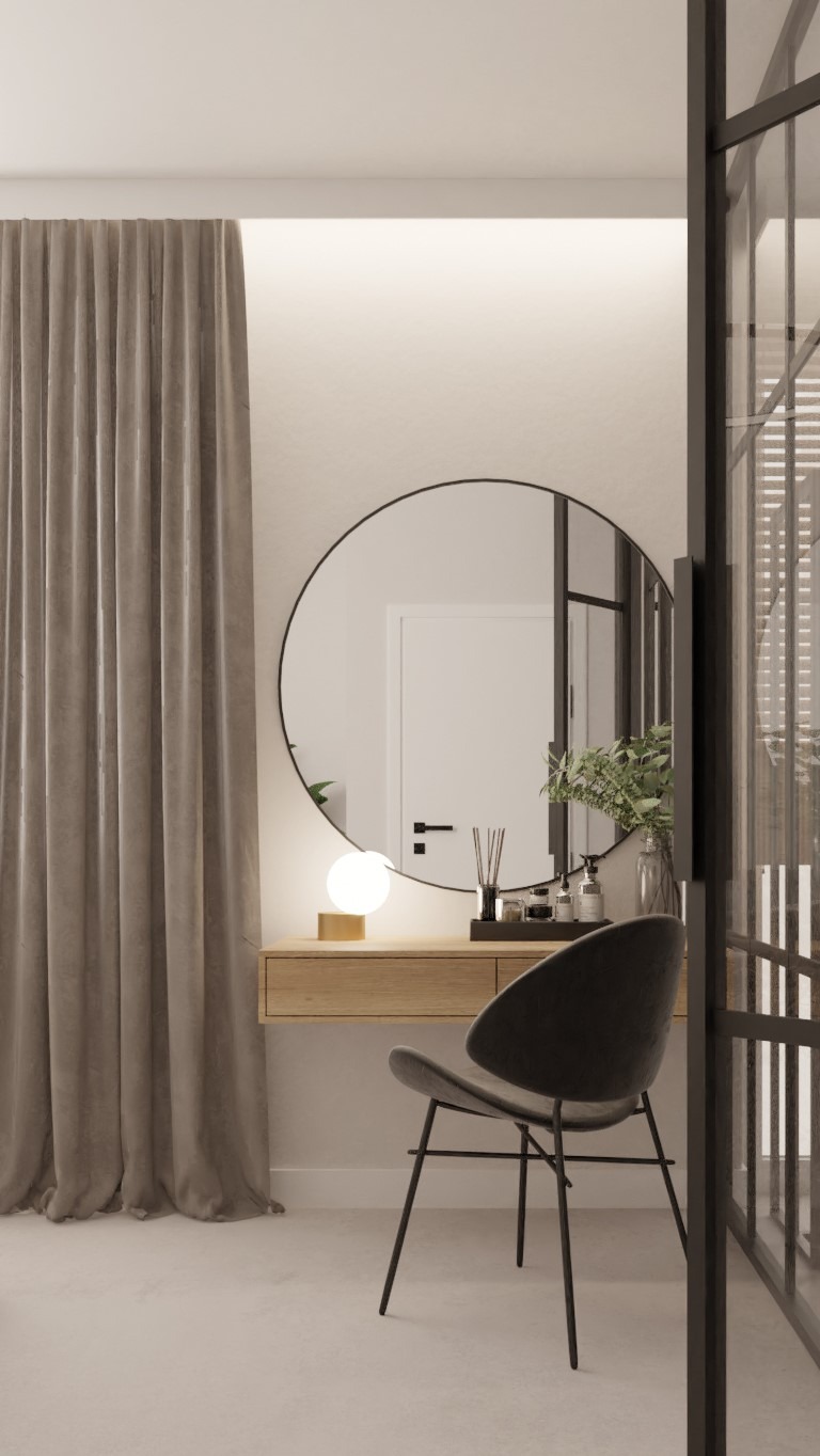 Nowoczesna toaletka z okrągłym lustrem, minimalistycznym krzesłem i beżową zasłoną, oświetlona kulistą lampką. Na blacie akcesoria do pielęgnacji i dekoracyjny bukiet w szklanym wazonie.