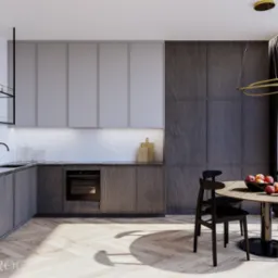 Nowoczesna kuchnia w odcieniach szarości z drewnianą podłogą w jodełkę, czarnym blatem z marmurowym wzorem, okrągłym stołem z owocami i złotą lampą wiszącą.