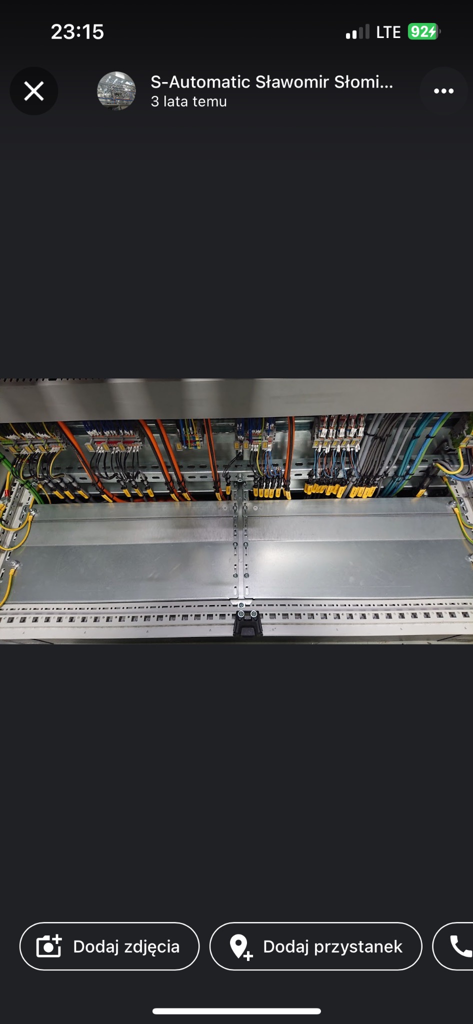 Wnętrze szafy sterowniczej z uporządkowanymi kablami elektrycznymi w kolorach żółtym, pomarańczowym, niebieskim i szarym, zamocowanymi na szynach DIN i listwach zaciskowych.