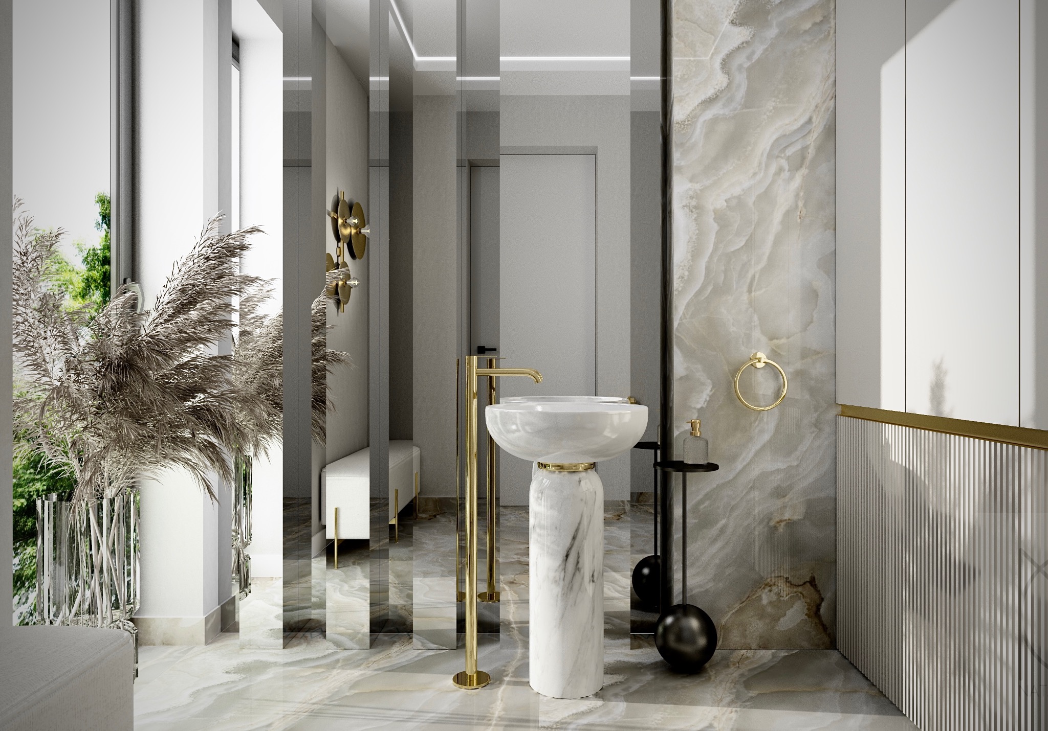 Elegancka łazienka z marmurową umywalką na postumencie, złotą armaturą i dodatkami, lustrzanymi panelami oraz dekoracyjną trawą w szklanym wazonie.