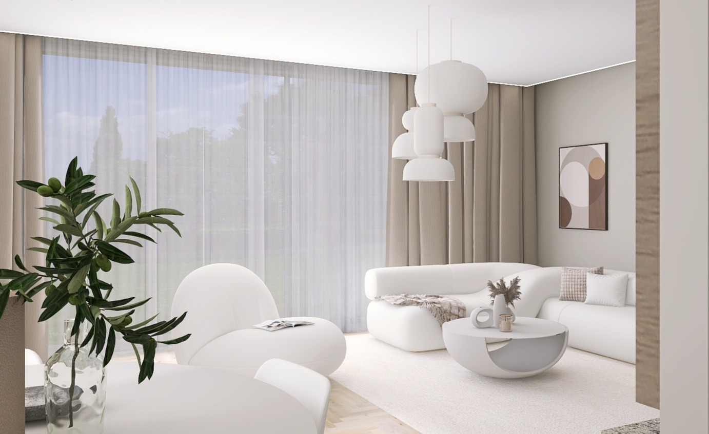 Jasne wnętrze salonu z białymi meblami o zaokrąglonych kształtach, minimalistycznym oświetleniem i dekoracyjną rośliną w szklanym wazonie na pierwszym planie.