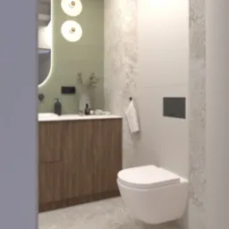 Nowoczesna łazienka z wiszącą toaletą, drewnianą szafką pod umywalką i okrągłym lustrem z podświetleniem. Beżowe płytki imitujące marmur na ścianach i podłodze.