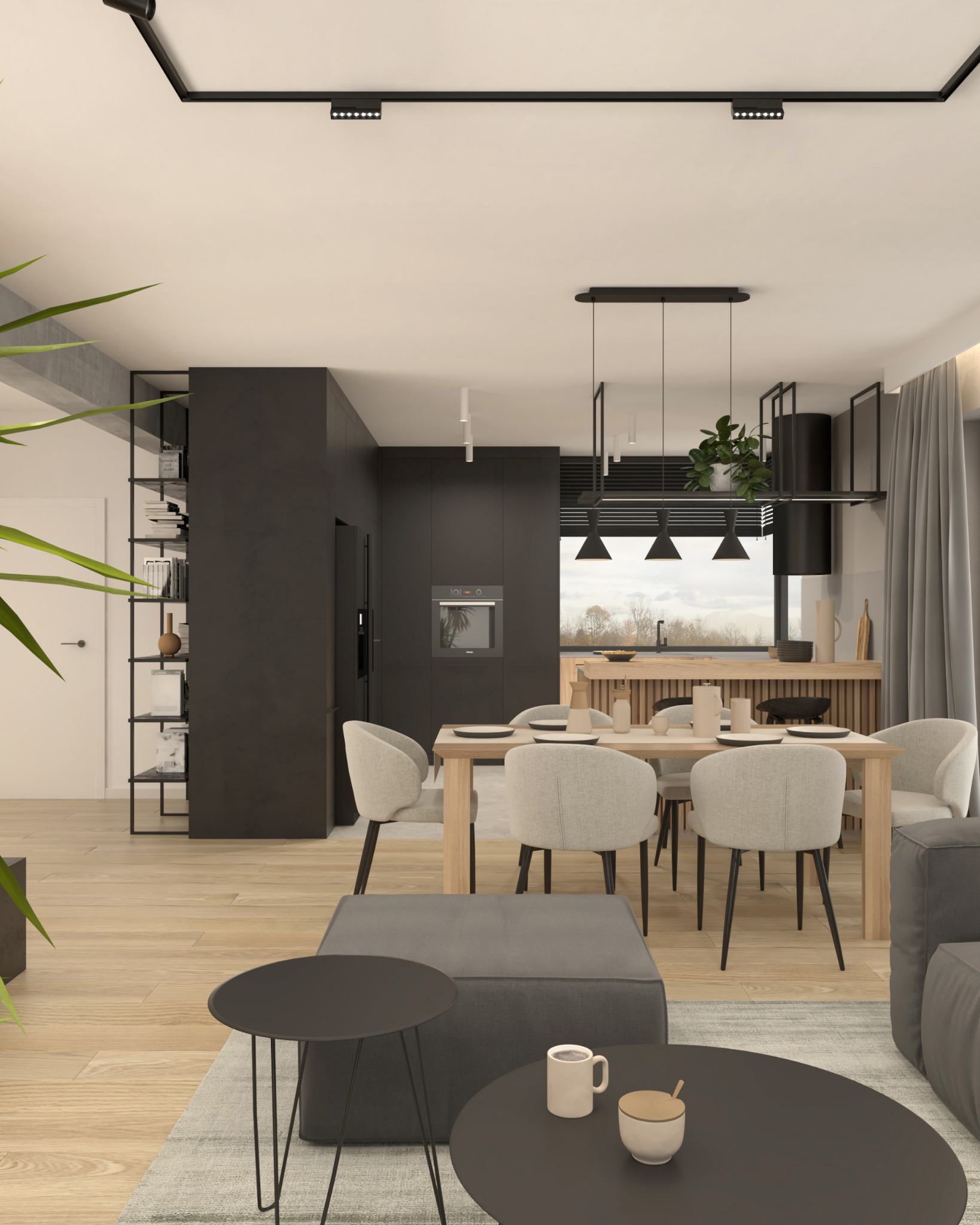 Nowoczesna aranżacja wnętrza z otwartą kuchnią, jadalnią i salonem. Czarna zabudowa kuchenna, drewniany blat roboczy, stół z jasnymi krzesłami, czarne stoliki kawowe i szara sofa.