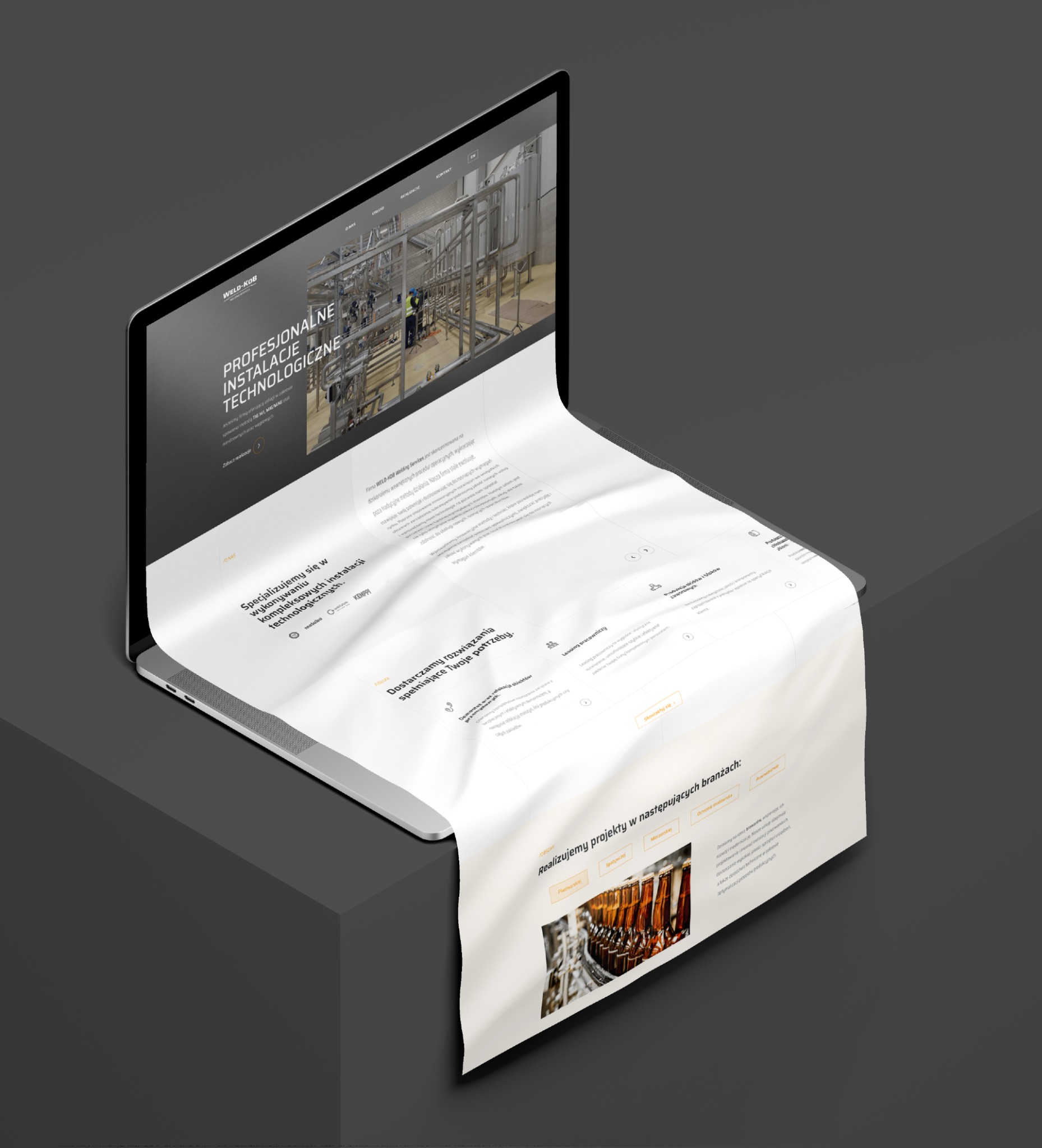 Laptop wyświetlający stronę internetową firmy Weld Kob, specjalizującej się w instalacjach technologicznych, z widocznymi elementami strony: logo, menu, teksty o specjalizacji w spawaniu metodami...