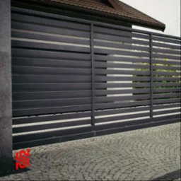 Nowoczesna przesuwna brama wjazdowa z poziomych metalowych profili w kolorze antracytowym, widoczna na tle kostki brukowej i fragmentu domu.