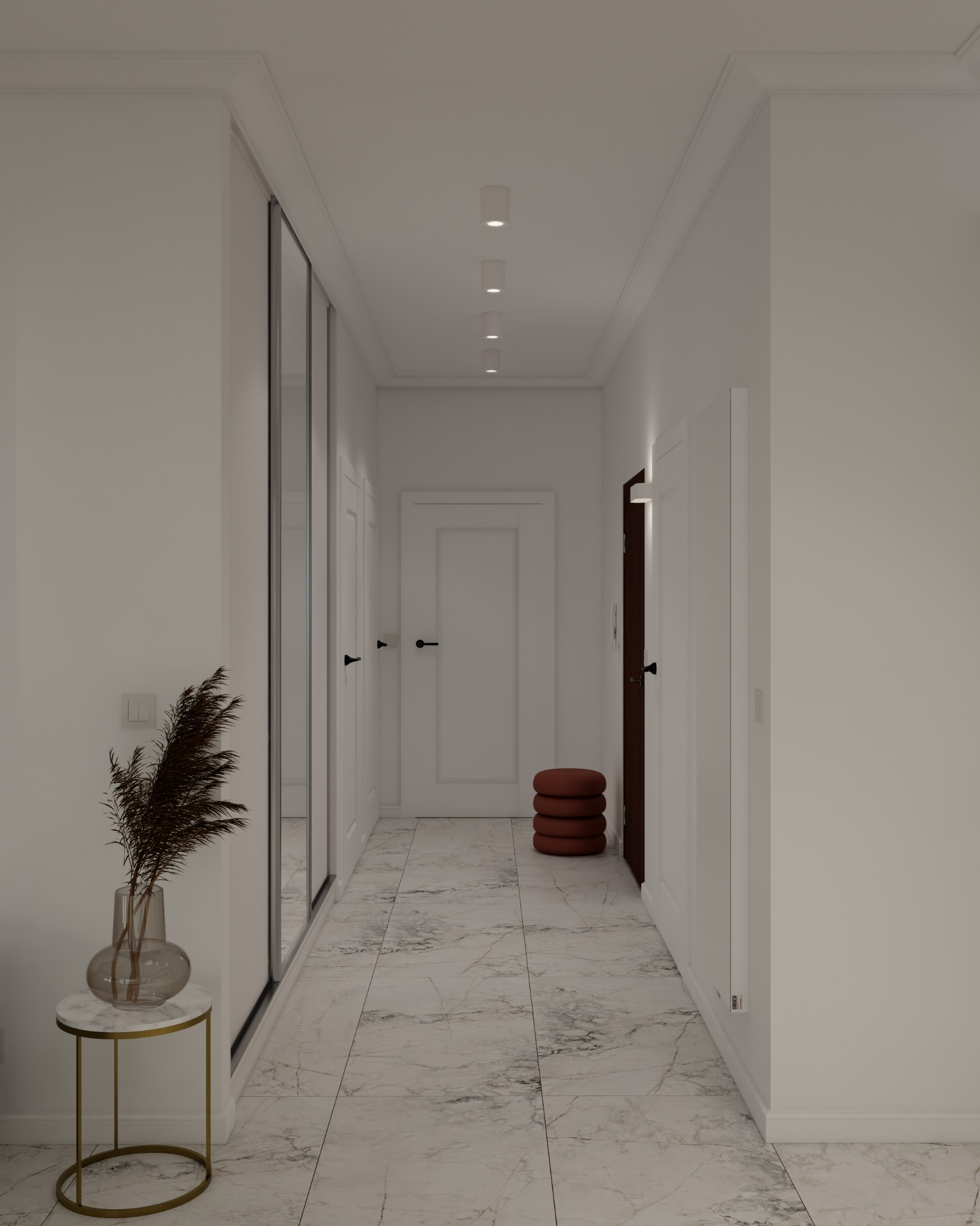 Korytarz w jasnych barwach z marmurową podłogą, lustrzaną szafą w zabudowie, okrągłym stolikiem z wazonem z suszonymi trawami oraz trzypiętrowym pufem.
