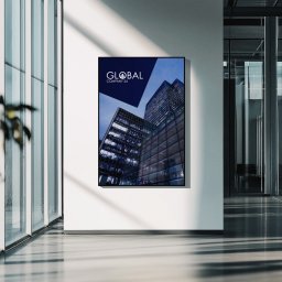 Strony Internetowe Agencja Interaktywna Pixelis - Wnętrze biura z plakatem 'Global Company 24' na ścianie. Minimalistyczny design, szklane ściany, roślina w doniczce. Stonowana kolorystyka, nowoczesna architektura.