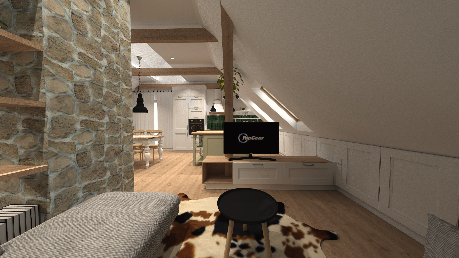 Wnętrze poddasza z kamienną ścianą, widok na kuchnię z wyspą, zabudowę pod skosem, telewizor z logo Top Gear i stolik na dywanie w krowie łaty.