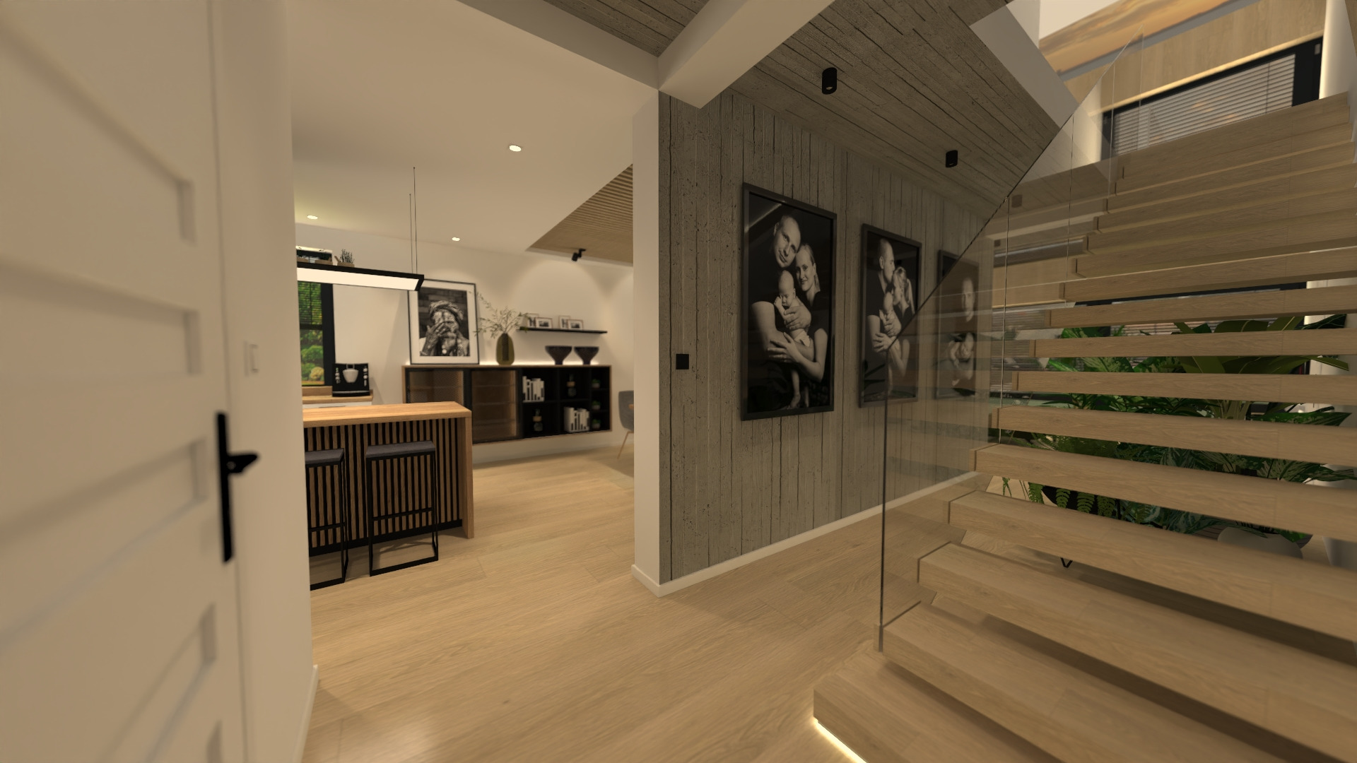 Wnętrze domu z drewnianymi schodami ze szklaną balustradą, widok na kuchnię z wyspą i czarne grafiki na ścianie z szarego betonu.