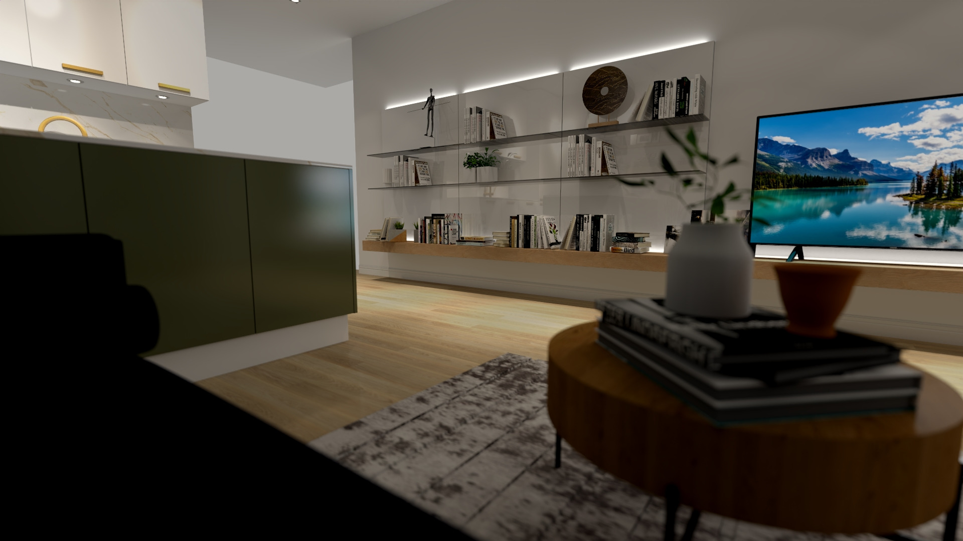 Wnętrze salonu z telewizorem i półkami na książki, widok na kuchnię z zielonymi szafkami, okrągły stolik kawowy z książkami i wazonem, dywan w odcieniach szarości.