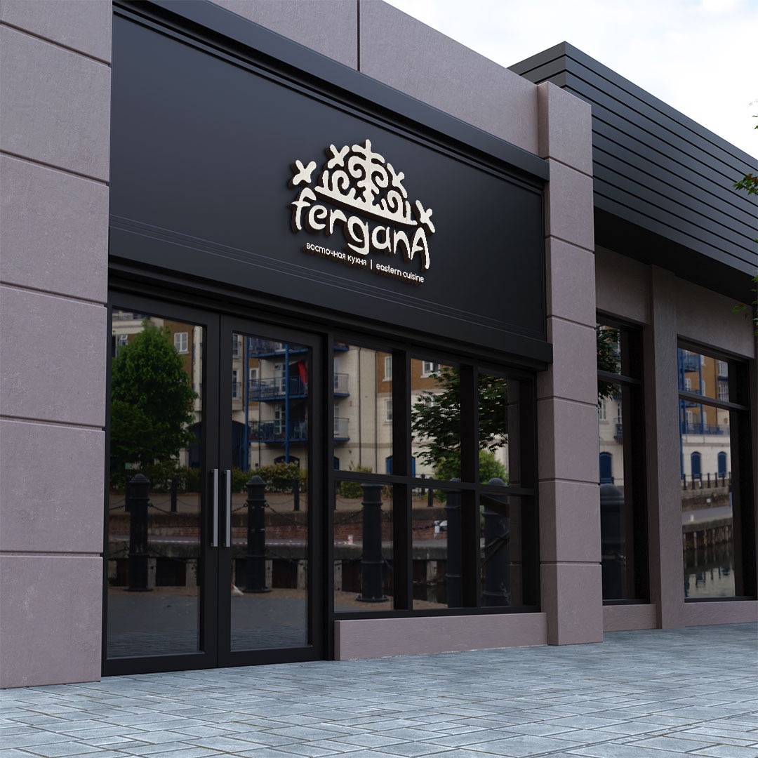 Elewacja budynku z logo restauracji Fergana Eastern Cuisine nad wejściem, widok z poziomu chodnika.