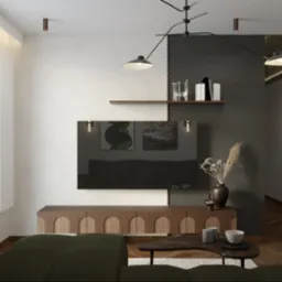 Nowoczesny salon z zieloną sofą, drewnianą szafką RTV i czarno-białą ścianą akcentową. Na ścianie półki z dekoracjami i czarny telewizor. Całość oświetlona wiszącą lampą.