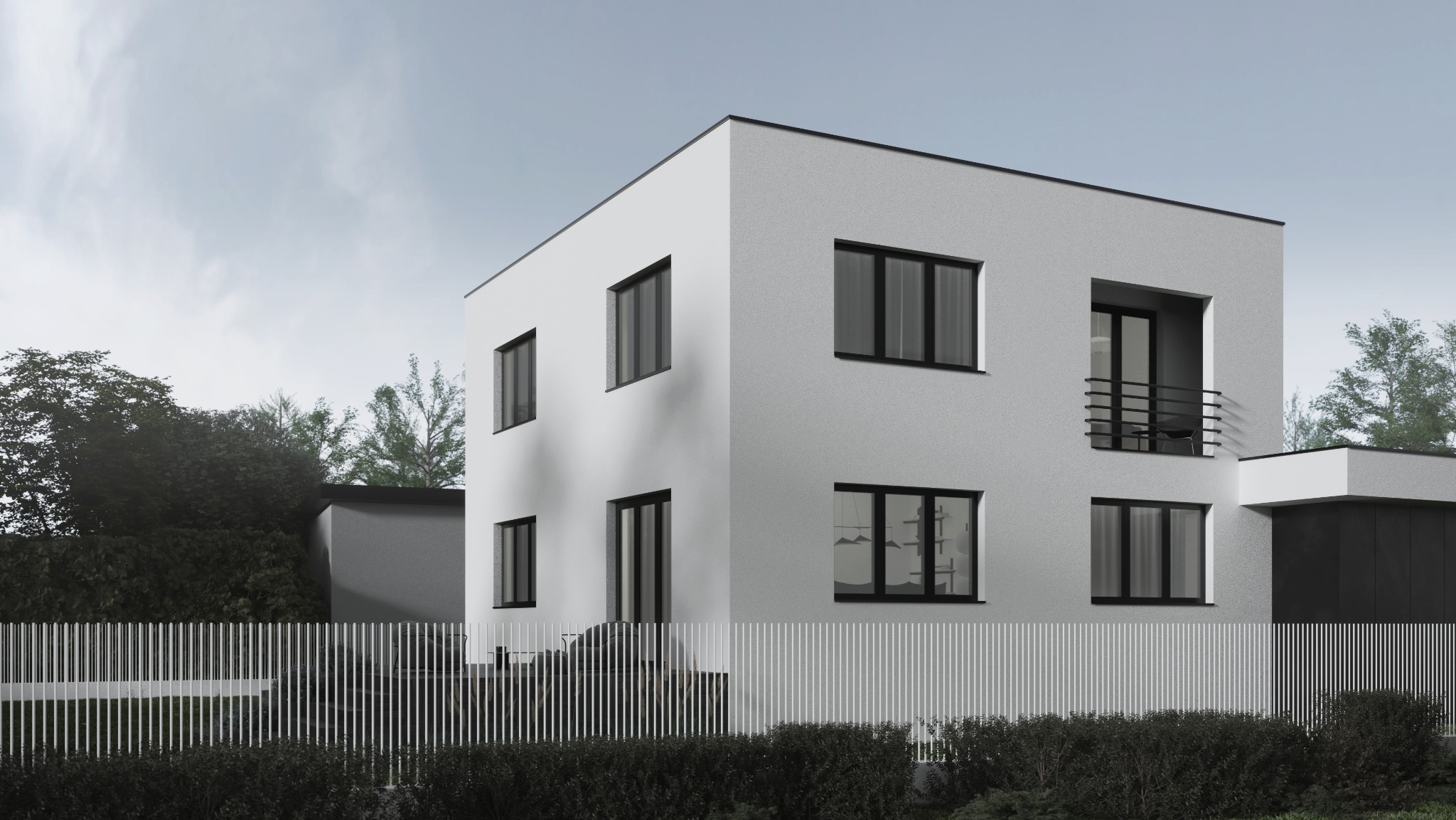 Dwukondygnacyjny dom w stylu minimalistycznym z białym tynkiem i czarnymi ramami okiennymi, otoczony białym ogrodzeniem i zielenią. Widok z zewnątrz w pochmurny dzień.
