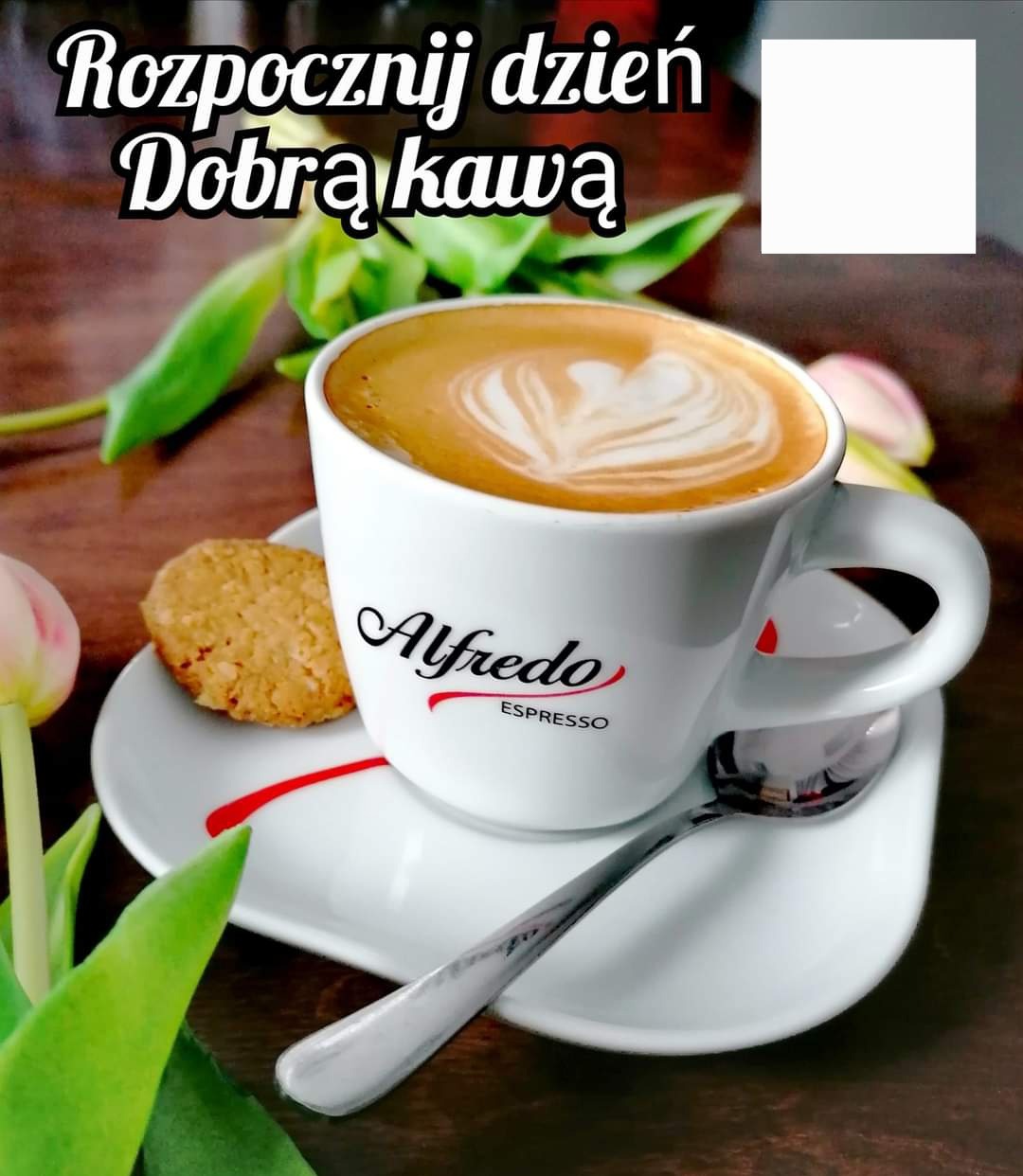 Filiżanka kawy Alfredo Espresso z pianką w kształcie serca, ciasteczko na białym spodku, srebrna łyżeczka, tulipan i napis 'Rozpocznij dzień Dobrą kawą'.
