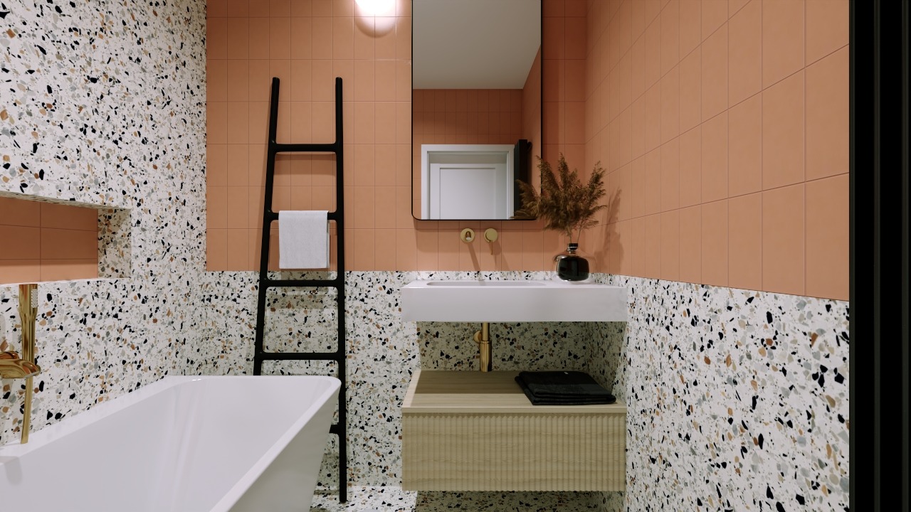 Nowoczesna łazienka z terazzo, koralowymi płytkami i czarną drabinką na ręczniki. Minimalistyczna umywalka i wanna tworzą spójną całość.