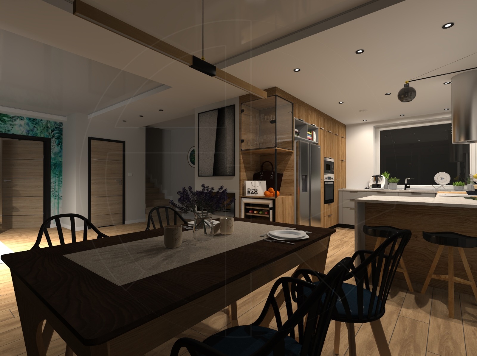 Wnętrze jadalni z ciemnym, drewnianym stołem i krzesłami, widok na kuchnię z drewnianymi szafkami, wyspą i oknem. Na stole dekoracje, w tle obraz i schody.