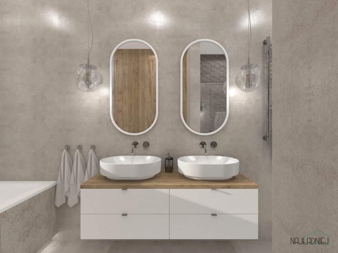Nowoczesna łazienka z dwoma umywalkami nablatowymi, owalnymi lustrami w białych ramach, wiszącą szafką z drewnianym blatem i szklanymi lampami wiszącymi.
