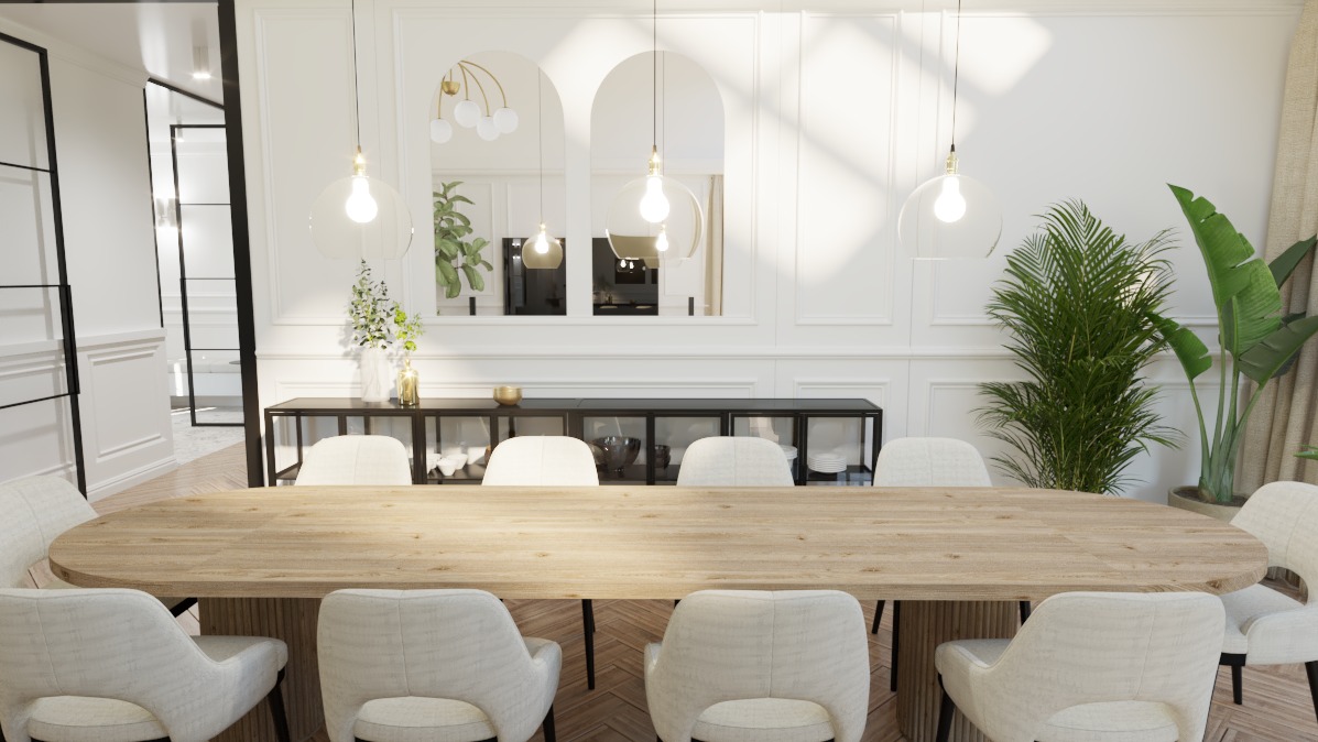Jasna jadalnia z owalnym drewnianym stołem otoczonym kremowymi krzesłami, oświetlona wiszącymi lampami z okrągłymi kloszami, z roślinami doniczkowymi i dekoracyjnym lustrem w tle.