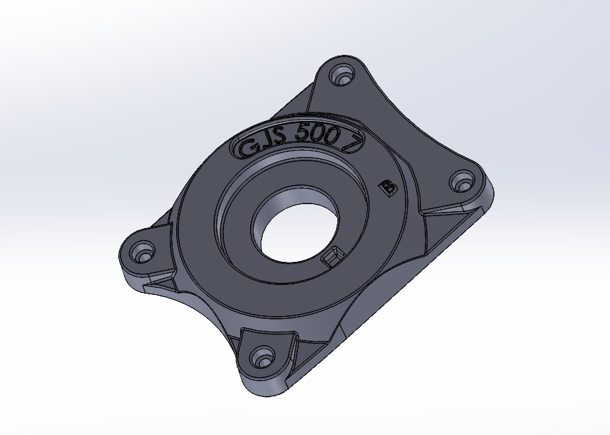 Model 3D metalowej obudowy z otworem, z napisem 'G.J.S. 500' w górnej części i oznaczeniem 'B' z boku, widoczne otwory montażowe