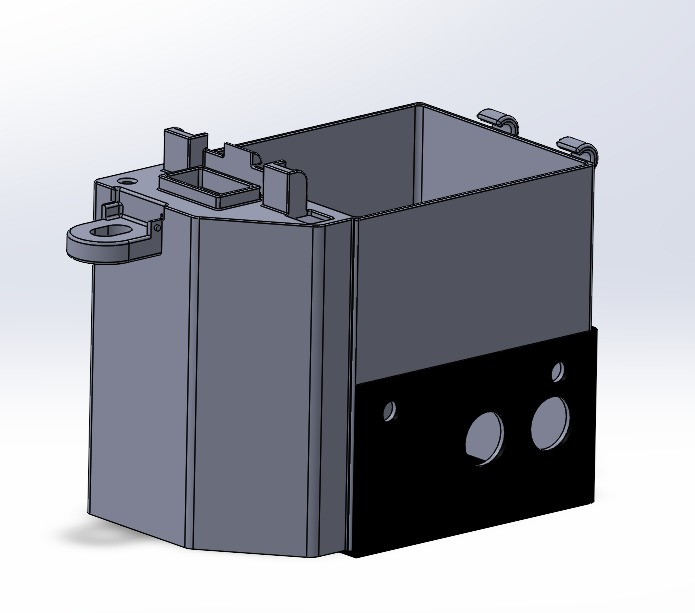 Model 3D obudowy urządzenia z czarnym panelem z otworami, widok izometryczny z lekko skierowanym światłem.