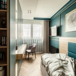 Komfortowa sypialnia z miejscem do pracy: zielone ściany z listwami, łóżko z turkusowym zagłówkiem, biurko z szarą krzesłem i regał z książkami.