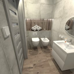 Niewielka łazienka w dwóch wersjach kolorystycznych ,w kolorze szarym i drewnianym. Tworzy to przytulne i eleganckie wnętrze, łączące naturalny urok drewna z nowoczesnymi i neutralnymi odcieniami szarości.