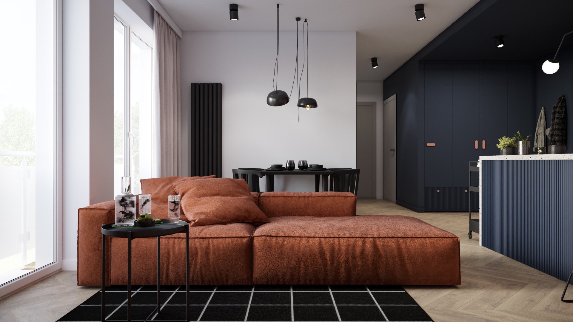 Nowoczesne wnętrze z ceglastą sofą modułową, czarnym stolikiem z dekoracyjnymi wazonami i ciemnoniebieską zabudową kuchenną w tle.