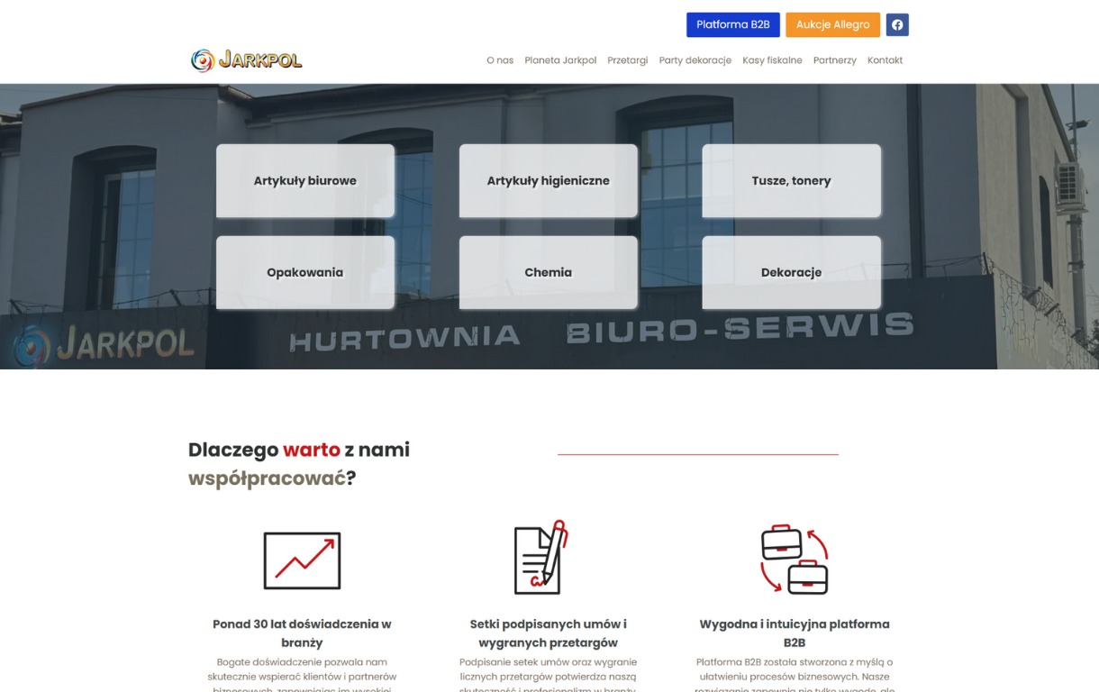Strona internetowa hurtowni biurowej Jarkpol z artykułami biurowymi, chemią, tuszami, tonerami i dekoracjami na tle budynku firmy. Platforma B2B.