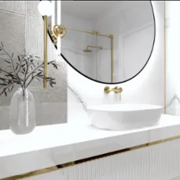 Nowoczesna łazienka z białym blatem, owalną umywalką nablatową, srebrnymi płytkami z teksturą, złotymi akcentami i okrągłym lustrem z podświetleniem. W wazonie dekoracyjna gałązka.