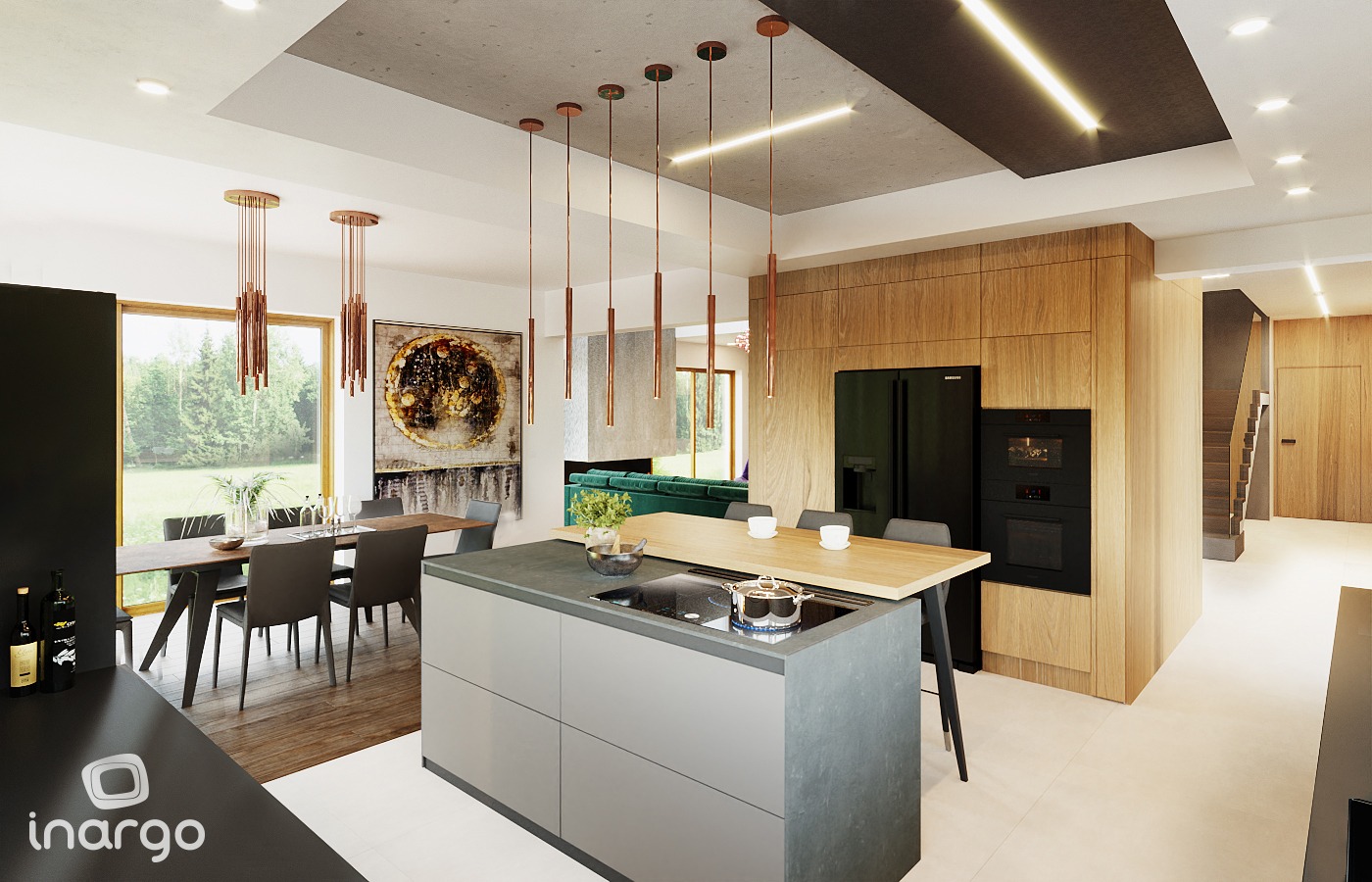 Wnętrze nowoczesnej kuchni z wyspą i drewnianymi akcentami, widok na jadalnię i salon z zieloną sofą. Nad wyspą wiszą podłużne lampy w kolorze miedzi.