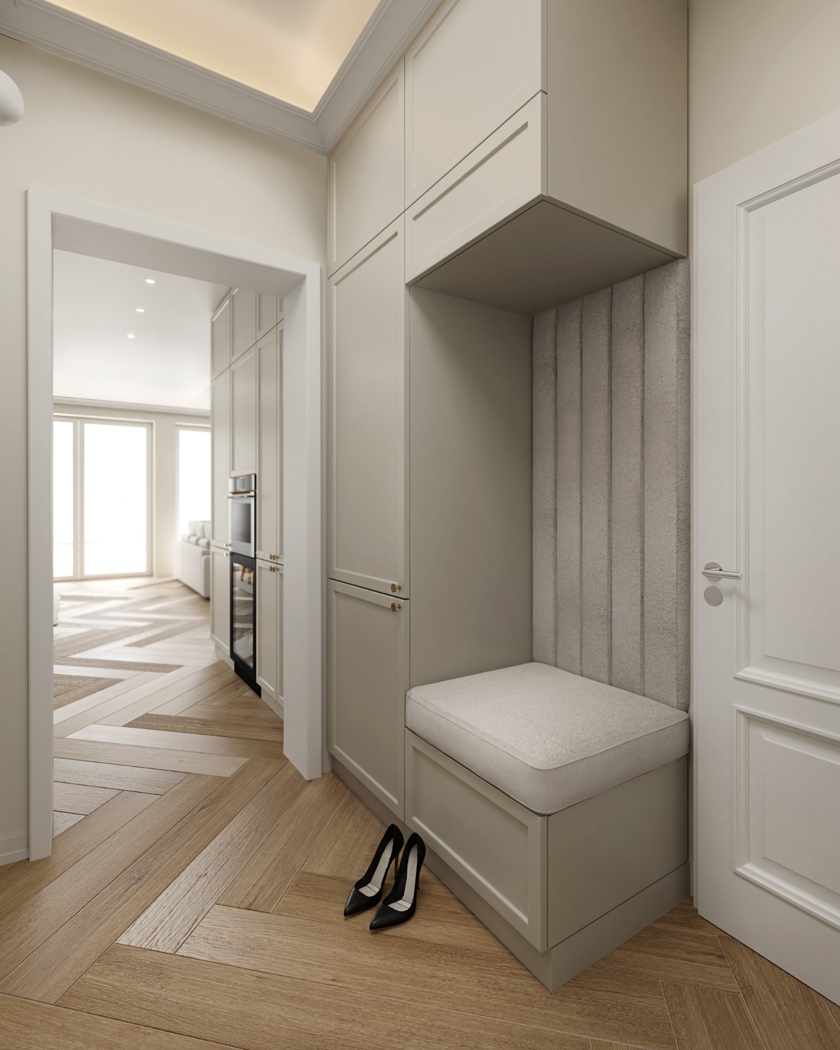 Hall z zabudową meblową w odcieniach beżu, siedzisko z tapicerowanym oparciem, parkiet w jodełkę, para czarnych szpilek na podłodze, widok na kuchnię w tle.
