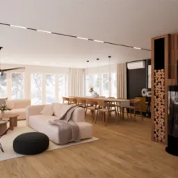 Przestronny salon z kominkiem obudowanym drewnianymi panelami, jasną sofą modułową, jadalnią z długim drewnianym stołem i krzesłami oraz designerskim fotelem motylkowym w kolorze burgundowym