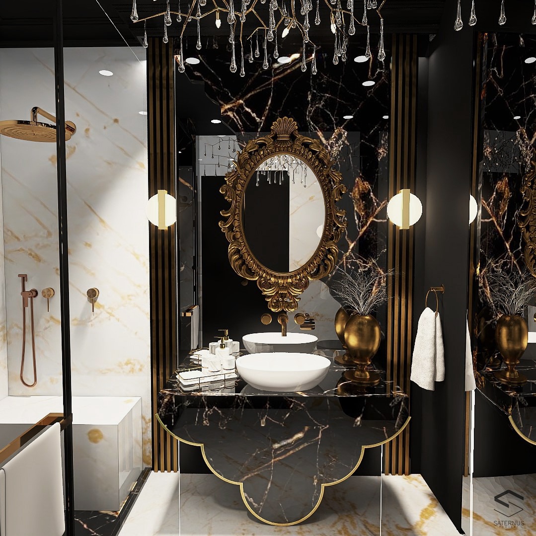Elegancka łazienka w czarno-złotej kolorystyce z marmurowymi ścianami, owalnym lustrem w bogato zdobionej złotej ramie, dwoma umywalkami nablatowymi i dekoracyjnym żyrandolem.