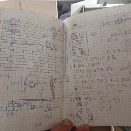 E .L .E .S . Instalacje elektryczne - Szkic instalacji elektrycznej, notatki w otwartym zeszycie w kratkę, z detalami technicznymi i oznaczeniami, widoczne symbole L, N, PE oraz wartości liczbowe.