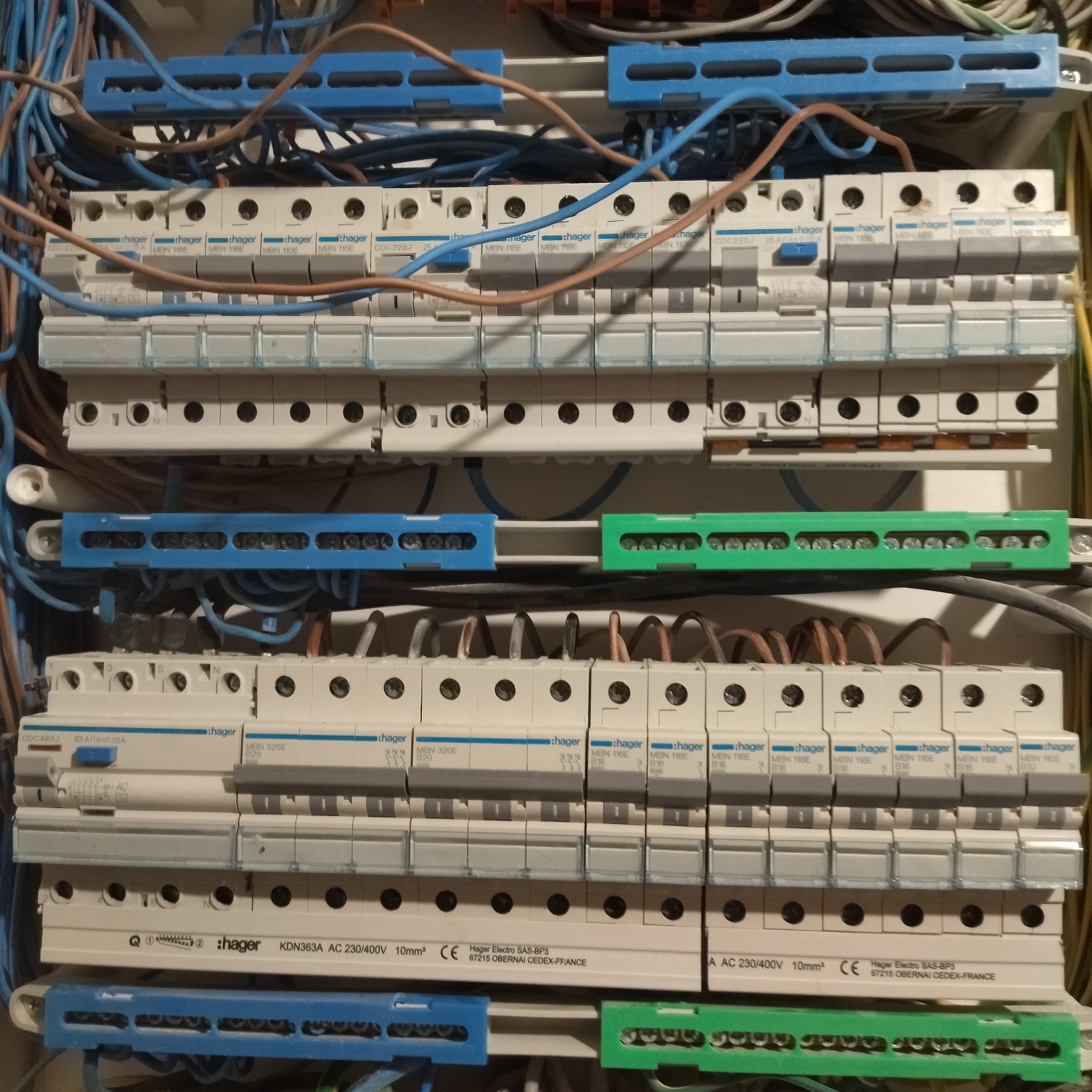 Rozdzielnia elektryczna Hager z zamontowanymi bezpiecznikami i przewodami. Widoczne elementy instalacji elektrycznej wewnątrz skrzynki rozdzielczej.