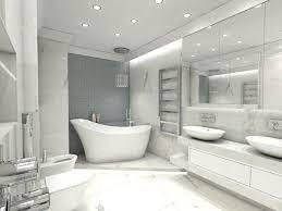 Elegancka, minimalistyczna łazienka w bieli i szarościach. Wolnostojąca wanna z baterią podłogową, umywalki nablatowe, duże lustro i oświetlenie punktowe tworzą spójną całość.