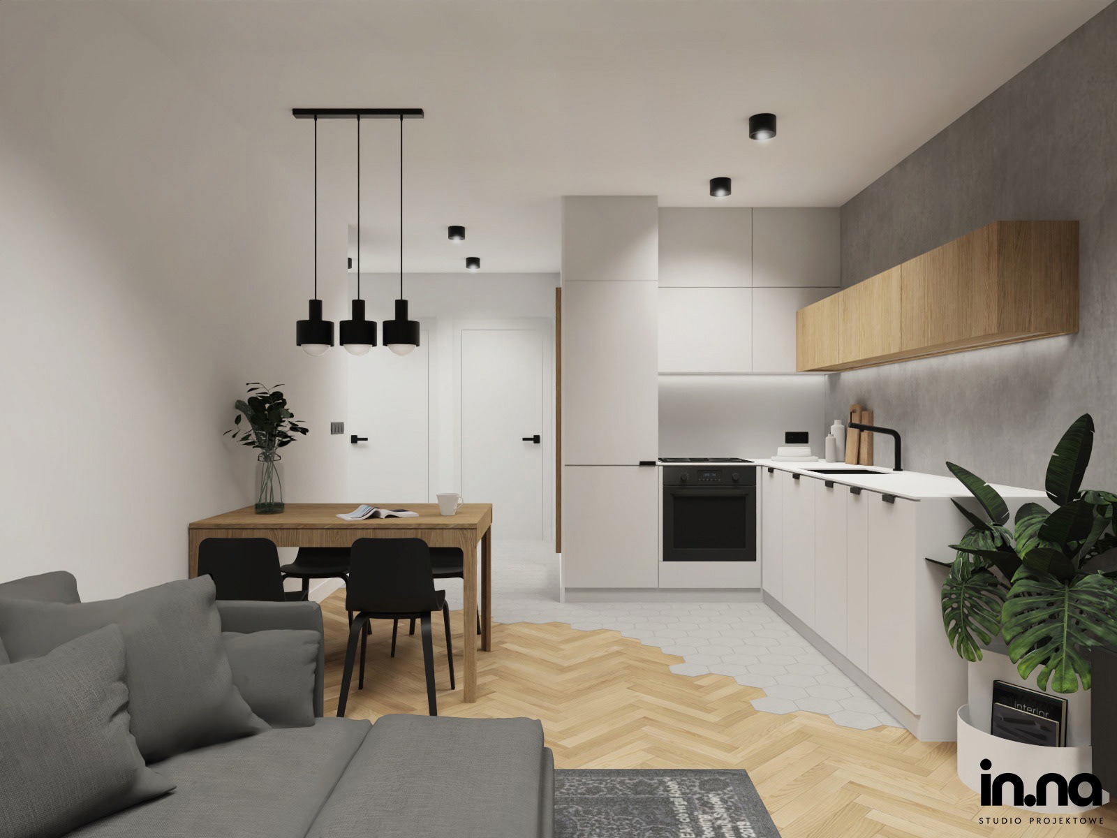 Nowoczesne wnętrze mieszkania z otwartą kuchnią, drewnianym stołem jadalnym, szarą sofą i parkietem przechodzącym w heksagonalne płytki.