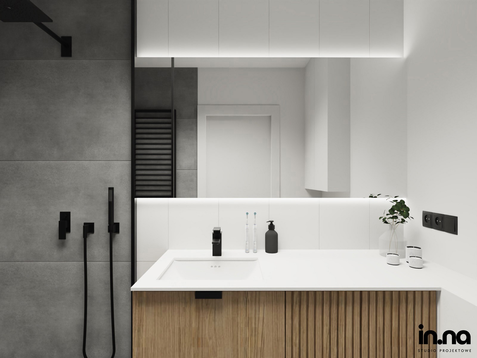 Nowoczesna łazienka z szarymi płytkami, czarną armaturą i szafką z drewnopodobnymi lamelami pod umywalką. Na blacie umywalkowym minimalistyczne akcesoria łazienkowe i dekoracyjna roślina w szklanym...