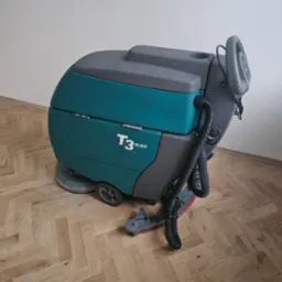 Profesjonalna, turkusowo-szara maszyna czyszcząca T3 na drewnianej podłodze ułożonej w jodełkę.