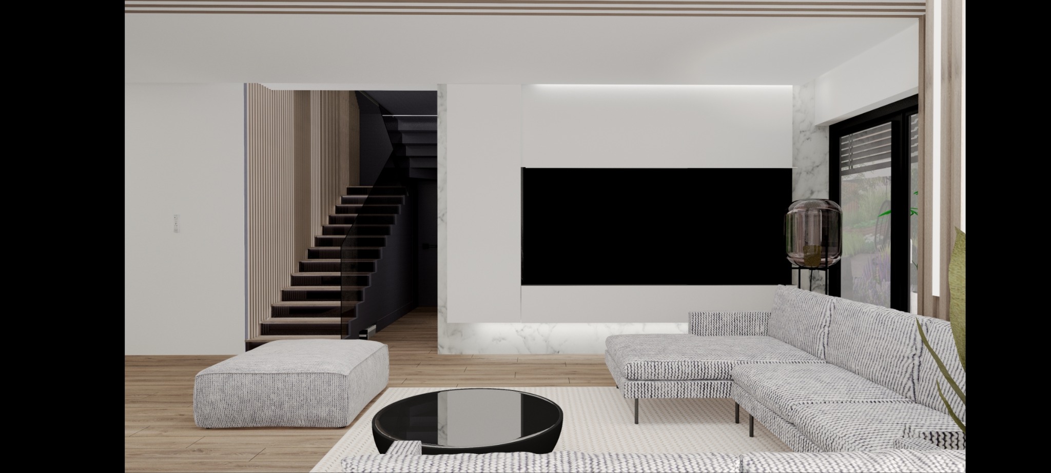 Nowoczesny salon z szarą sofą narożną, czarnym stolikiem kawowym i schodami z drewnianymi stopniami w tle.