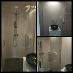 Wykończona łazienka z kabiną prysznicową ze złotą armaturą, umywalką w kolorze butelkowej zieleni i heksagonalną mozaiką pod prysznicem.