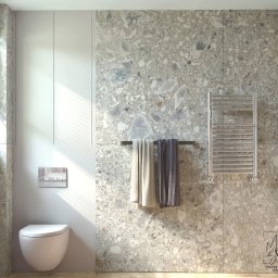 MM-Studio Projektowanie Wnętrz Marcin Martela - Nowoczesna łazienka z toaletą podwieszaną, grzejnikiem drabinkowym i ścianą wykończoną płytkami imitującymi lastryko w odcieniach szarości. Minimalistyczny design.