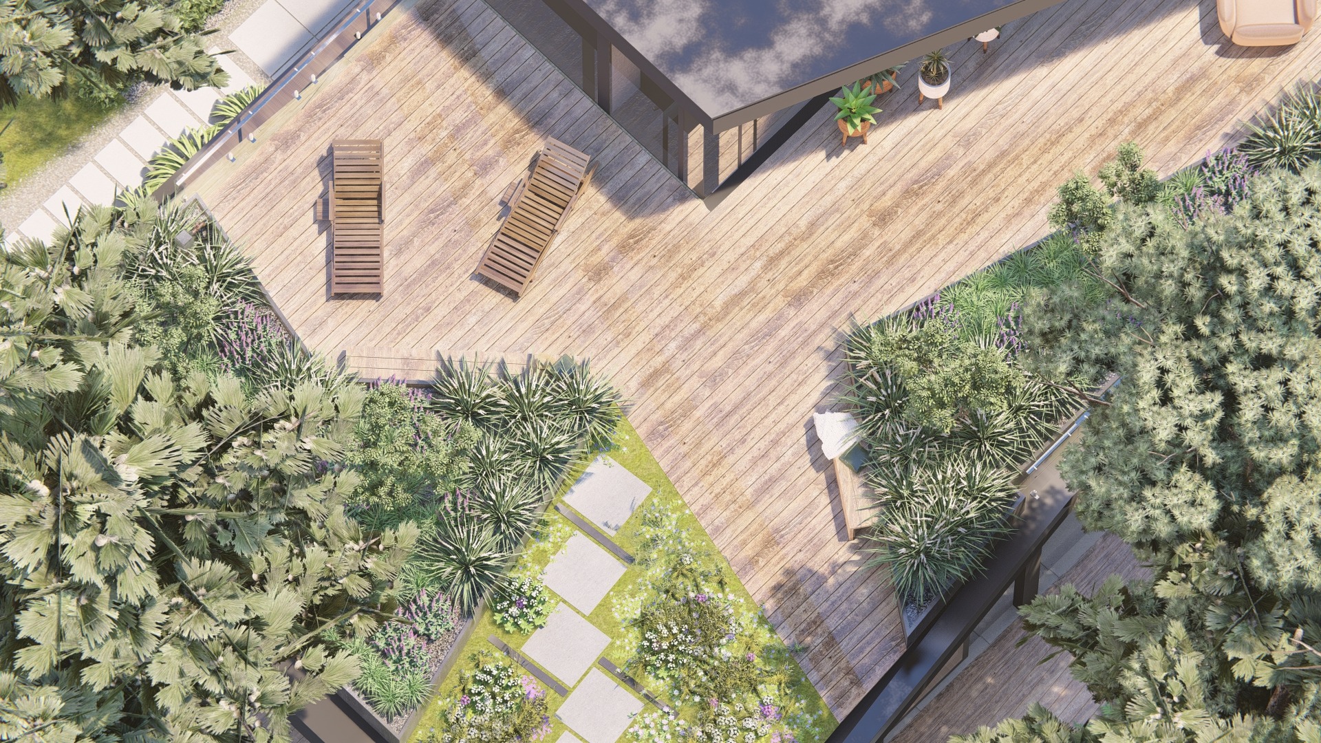 Widok z góry na drewniany taras z leżakami, otoczony bujną roślinnością, w tym trawami ozdobnymi, kwitnącymi bylinami i drzewami, z ścieżką z płyt betonowych prowadzącą przez rabatę.