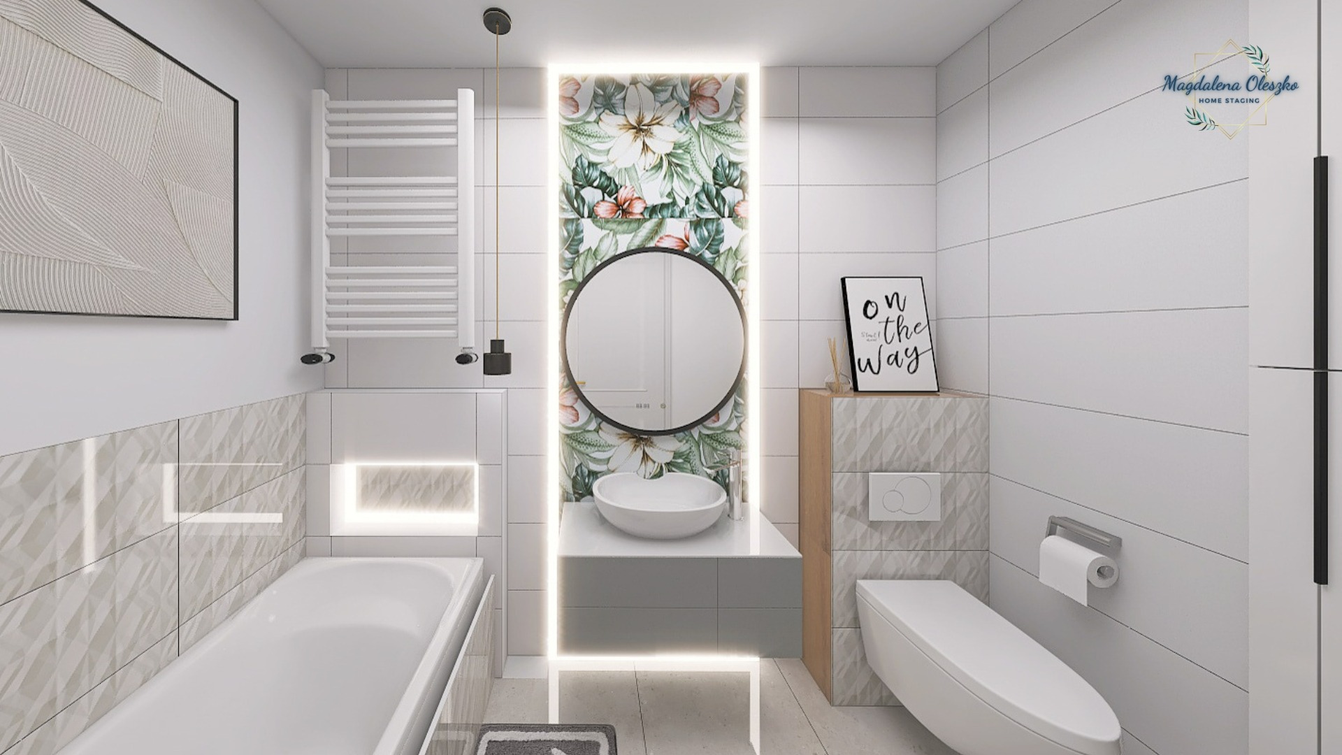 Nowoczesna, jasna łazienka z białymi płytkami, okrągłym lustrem nad umywalką, podświetlanym panelem z motywem kwiatowym, grzejnikiem drabinkowym i minimalistycznymi dodatkami.