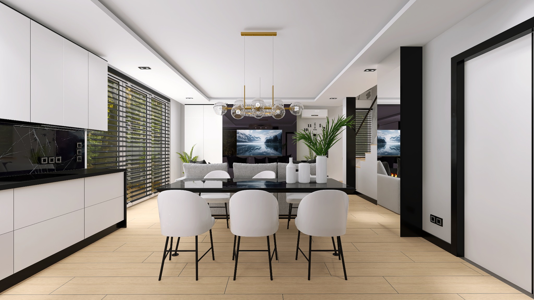 Nowoczesne wnętrze: białe szafki kuchenne z czarnym blatem i marmurowym panelem, stół z białymi krzesłami, dekoracyjne oświetlenie i widok na salon z telewizorem.