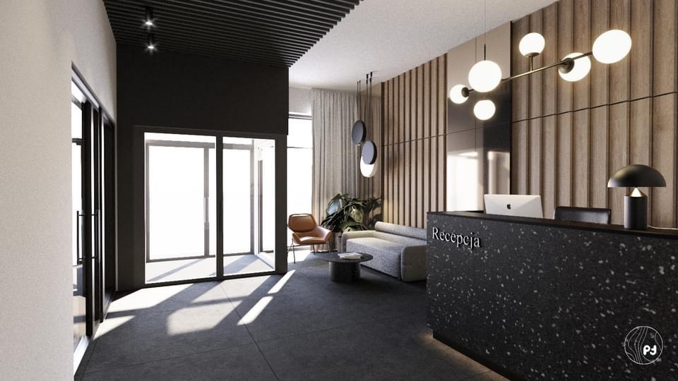 Nowoczesne wnętrze biura w Raniżowie z recepcją z czarnego lastryko, minimalistycznym oświetleniem i strefą oczekiwania z szarą sofą i roślinami.