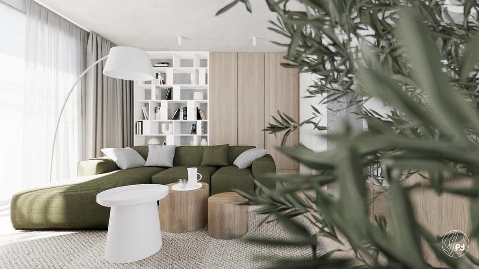Wnętrze salonu w neutralnych barwach z zieloną sofą, drewnianymi stolikami i białą biblioteczką w tle, z rośliną na pierwszym planie.